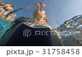 Under water mother supports daughter in the pool 31758458