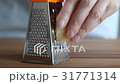 Woman hands grating parmesan cheese  31771314