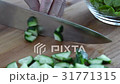 A large knife on the board chopped cucumbers  31771315