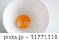 Egg yolk falling in glass bow. Food ingredient. 31771318