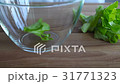 Closeup of falling  green llettuce on glass bowl.  31771323