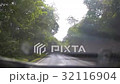 Driving on a  road in rain with windscreen wipers 32116904