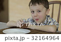 Little boy eating cake at home 32164964