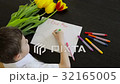 Happy little boy makes a holiday card for his mom  32165005