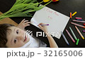 Happy little boy makes a holiday card for his mom  32165006