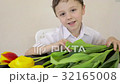 Happy little boy makes a holiday card for his mom  32165008