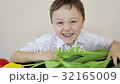 Happy little boy makes a holiday card for his mom  32165009