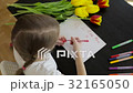 Happy little girl makes a holiday card for his mom 32165050