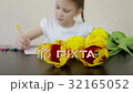 Happy little girl makes a holiday card for his mom 32165052