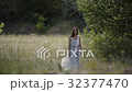 Beautiful girl is walking along a country road 32377470
