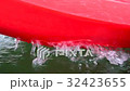 Red canoeing splashing water. 32423655