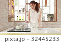 A woman who cooks for a fashionable smartphone reference 32445233