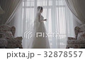 Bride looks out of the window,wedding day 32878557