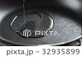Pouring olive oil over a pan 32935899