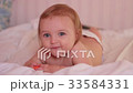 Smiling baby lying on tummy 33584331