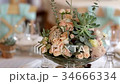 Fresh flower decoration on a wedding party table 34666334