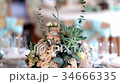 Fresh flower decoration on a wedding party table 34666335