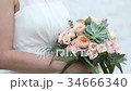 Bride holding wedding bouquet 34666340