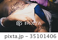 Tattoo artist is working on the drawing 35101406