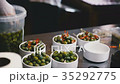 Cooks spread the olives in bowls 35292775