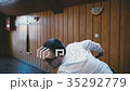 Young guy swings a cue to hit the ball 35292779