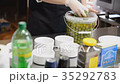 Olives are put in white bowls in the kitchen 35292783