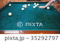 Man with a cue in his hands aims at the ball 35292797