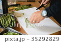 Cook cuts bean pods 35292829