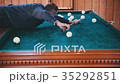 Man rolls the ball into the hole 35292851