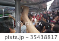 Hand holds rails on subway train 35438817