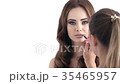 Makeup artist making makeup for a beautiful girl.  35465957