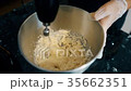 Confectioner fast mixer mixes the egg yolks and 35662351