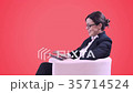 Business woman with glasses sitting in the Studio 35714524