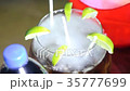 Cocktail in a glass with lime divided into slices 35777699