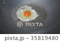 A fried egg with oil on pan 35819480