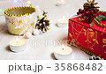 burning candles, a red gift box and decorative 35868482