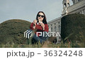 Happy Young Woman Enjoying an Ice Cream Sitting On 36324248