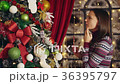 Woman decorating the Christmas Tree at home 36395797