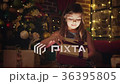 Little girl surprised by a Christmas gift 36395805