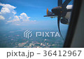 Wing of an airplane flying through the blue sky. 36412967