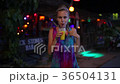 Close up of woman drinking juice cocktail in a 36504131