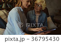 Nice woman reading a fashion magazine with her 36795430