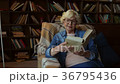 Delighted senior lady reading a book at home 36795436