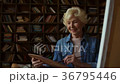 Happy senior woman drawing at home 36795446
