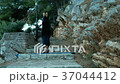 Woman standing on his head on stone steps on Woman standing on his head on stone steps on 37044412