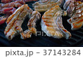 Grilled pork on stove. 37143284