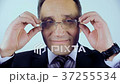 The man takes off his glasses, looks at them, then 37255534