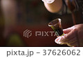 Soy sauce flowing over spoon. 37626062