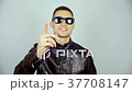 A young man wearing black glasses and a black 37708147