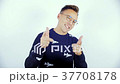 A young man in a blue sweater and glasses at a 37708178